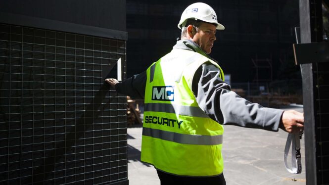 MC security worker walking and talking on a two way radio