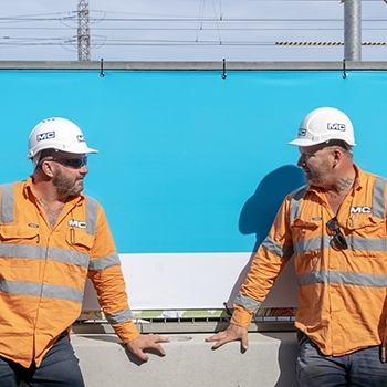 two mc labour construction workers having a chat