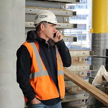 MC Labour construction worker talking on the phone